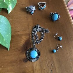 Bundle of turquoise colored necklace, dangle earrings, and three silver and turquoise rings. All rings are adjustable fit any size.