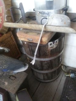 Very old wooden barrel with metal ring and plug in bottom