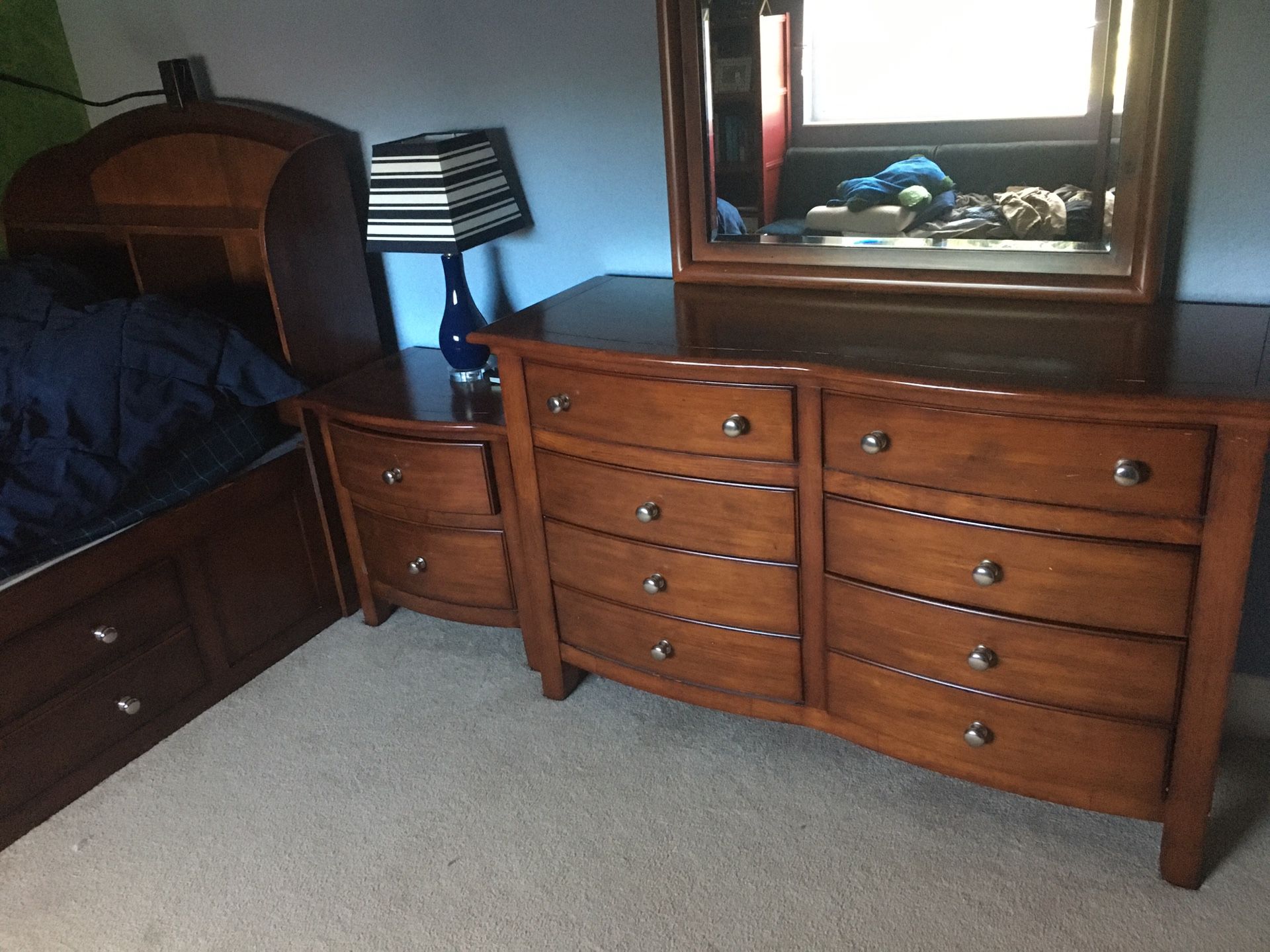 Kids bedroom set: twin bed with storage on bottom and headboard shelves, dresser with mirror, and 1 nightstand. Used but good shape