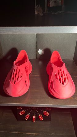 and a half Adidas Yeezy Foam Runner Red  I don’t know the size of them but I guess is 11 and 11 a half