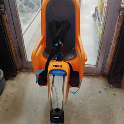 Thule RideAlong rear-mounted child bike seat in orange.