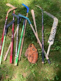 Hockey sticks and baseball bat and mitt