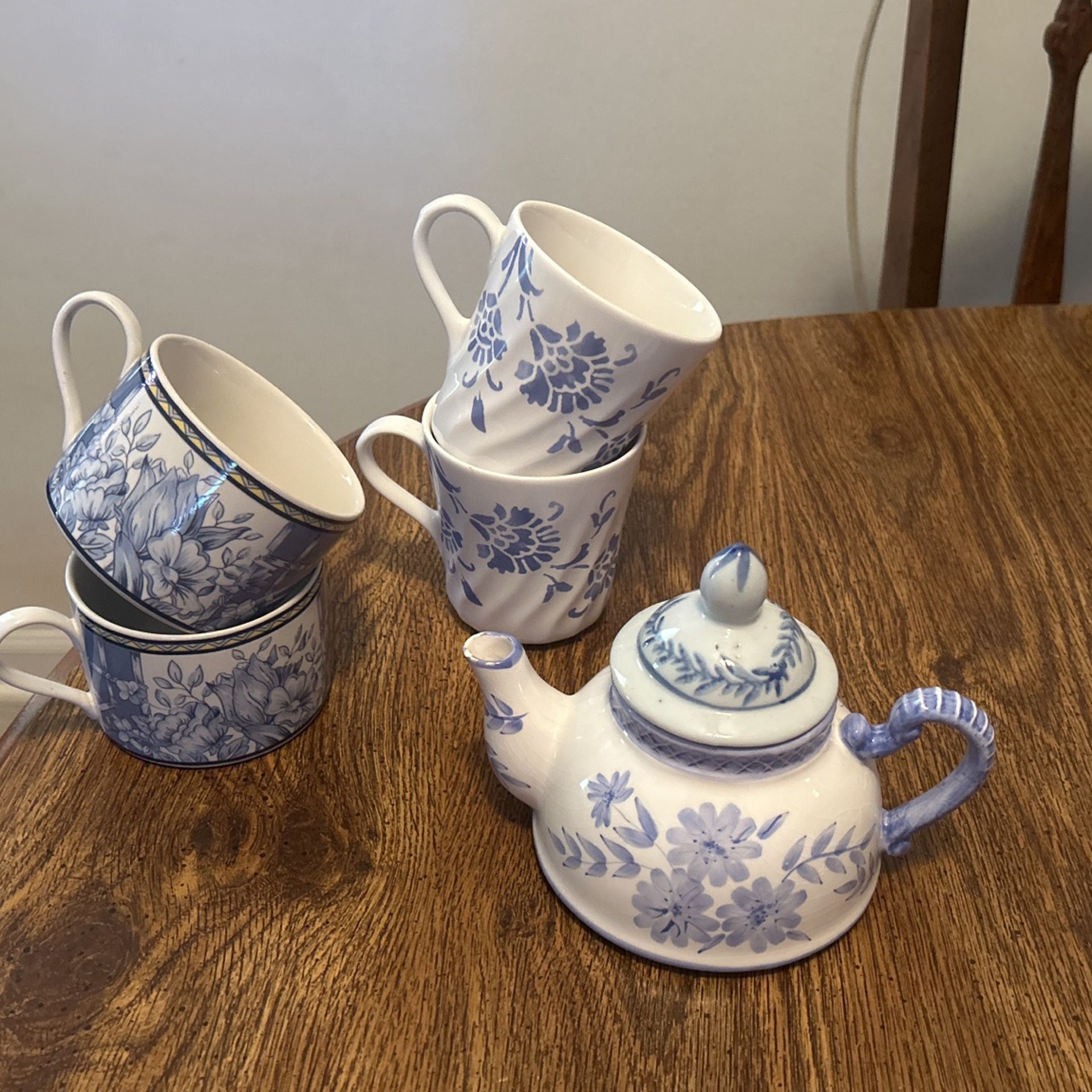 Four Coffee Cups And A Tea Pot