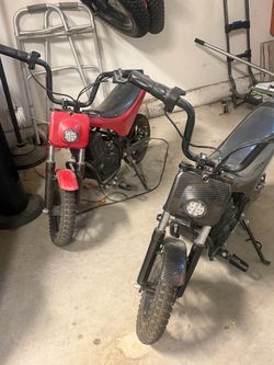 Two Electric Mini Dirt Bikes – Red & Black – Chargers Included