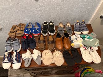 Assorted of various kids shoes and socks in different styles and sizes from newborn to size 6
