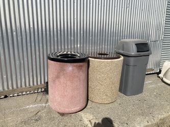 2 concrete outside trash containers and one Rubbermaid outside trash container