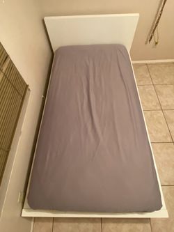 Twin Bed with White Frame + Mattress + Mattress Cover – $25