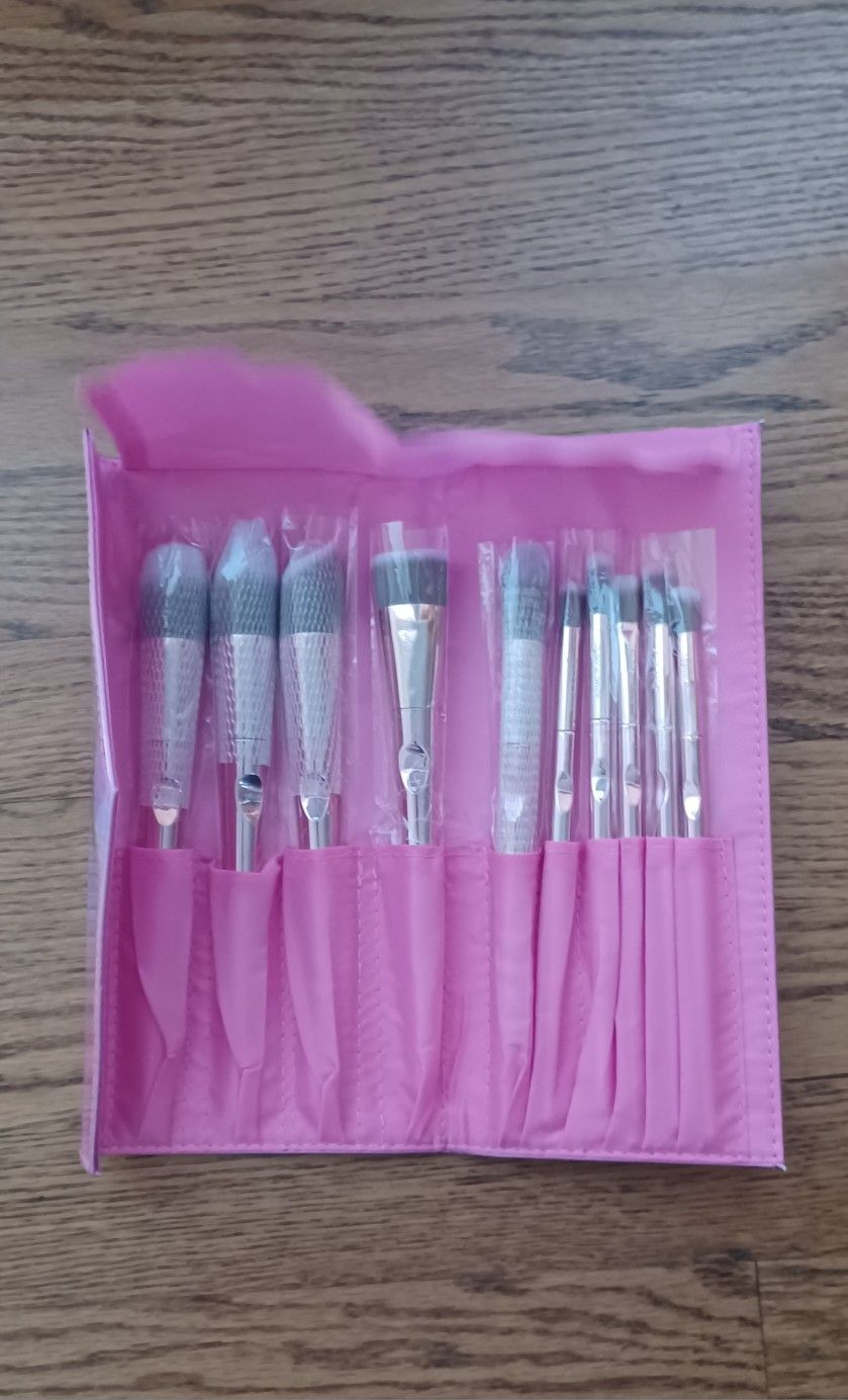 10 piece makeup brush set with case, pink metallic handles Styled in Grace brand $15 each Set New never used