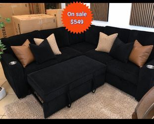 Stylish black sectional sofa with pull-out bed and storage