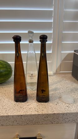 Empty 1942 and Cincoro bottles