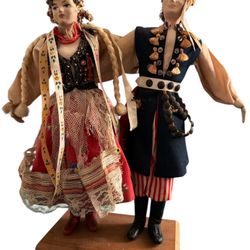 These are vintage handmade Polish folk art dolls, likely representing a couple from the Krakow region, dressed in traditional costumes.  The dolls are
