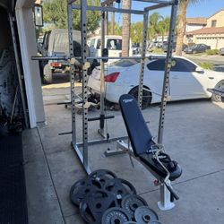 Bench press/squat rack with pulley system and 7ft 45lbs bar plus 265lbs of Olympic weights