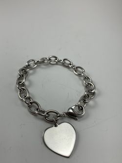 Silver tone bracelet with heart pendant