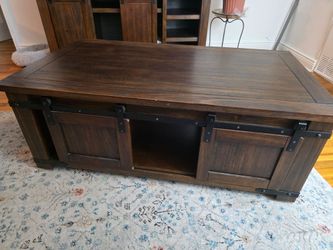 On wheels: Dark Wood Coffee Table with Sliding Doors