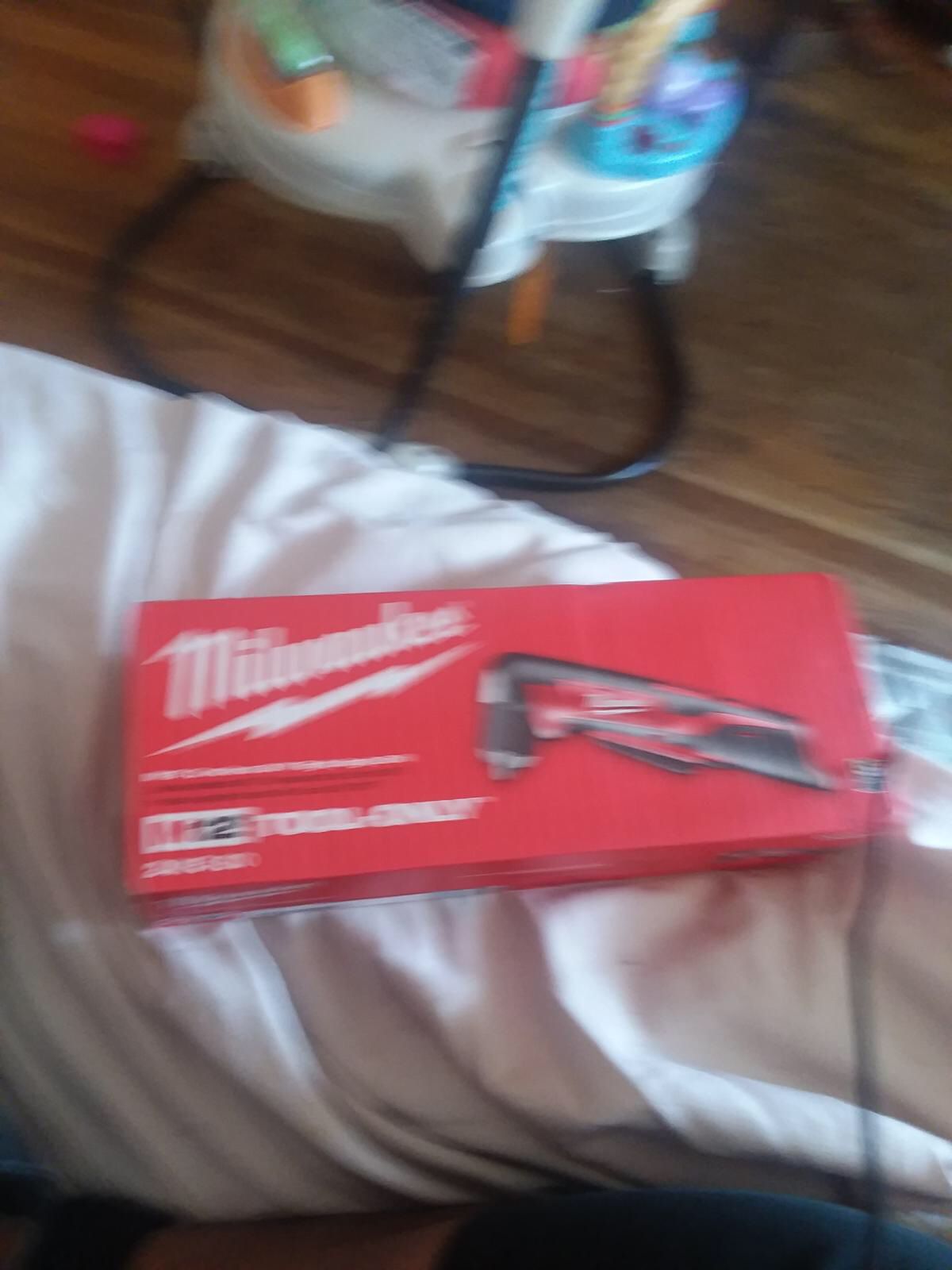 Two Milwaukee rotary tools and one right angle one flashlight