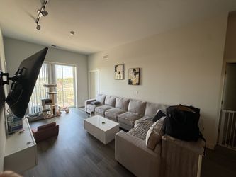Gray linen sectional and white coffee table