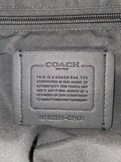 This is a black Coach Graham Pack sling bag, a versatile leather