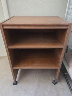 Brown wood shelf on wheels