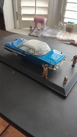 Two Hommies with a dog and Chevy Impala