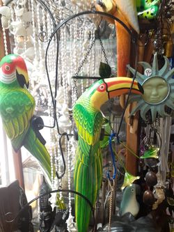 Your choice of either colorful carved wooden birds on swing