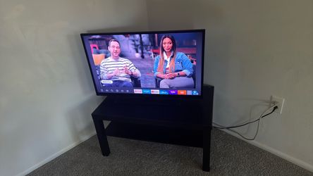 Black Sanyo Tv with Amazon fire stick and  black tv stand