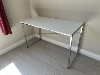 Brand new Simple white desk with a sturdy metal frame.