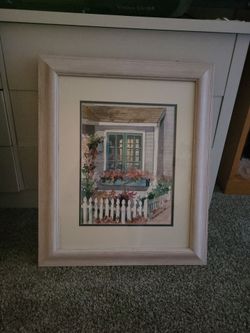 Framed and matted watercolor art print depicting a cozy cottage