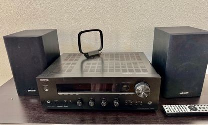 Onkyo TX-8050 network stereo receiver paired with two Polk Audio bookshelf speakers, an AM loop antenna, and a remote control.