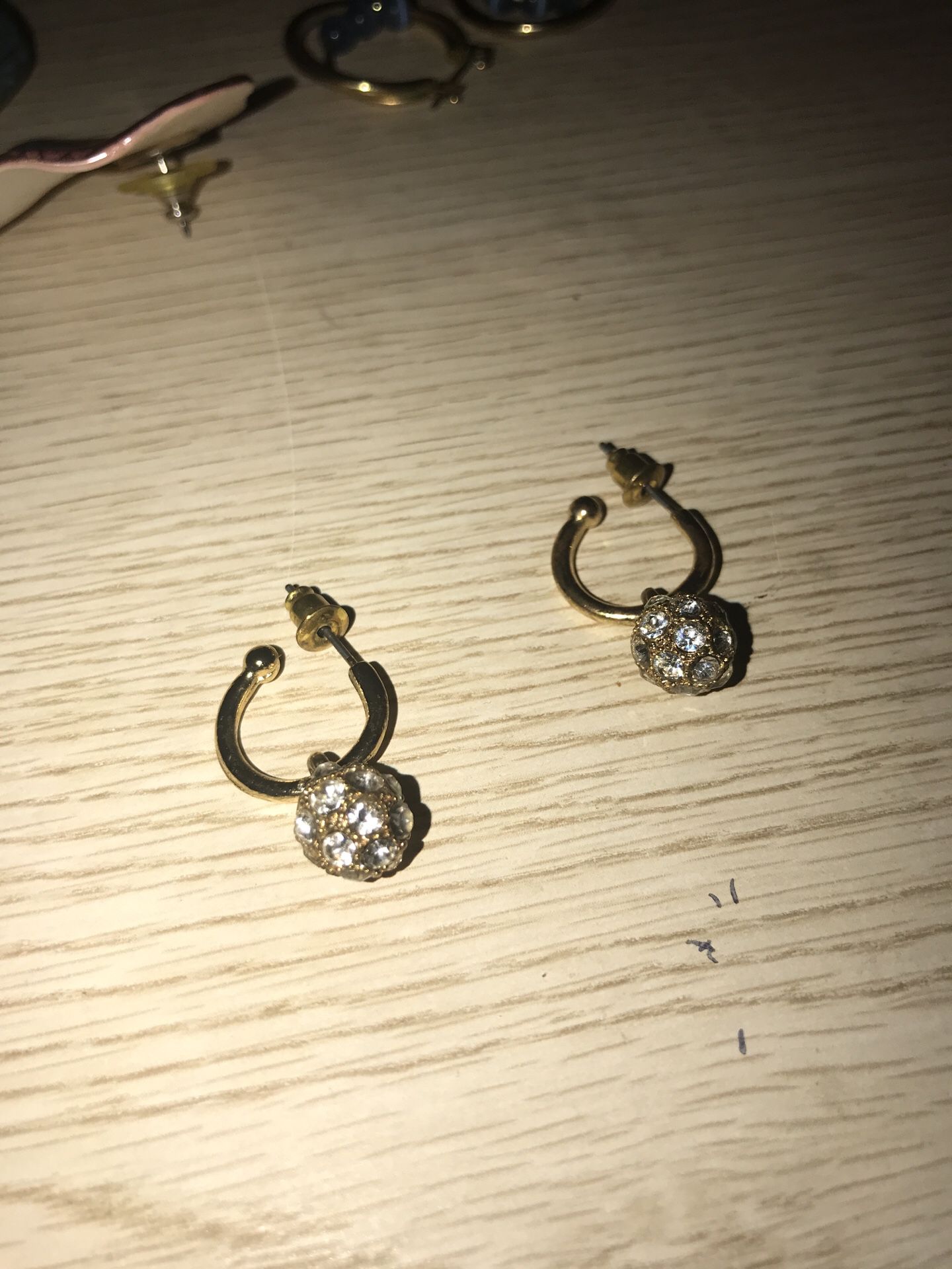 Gold Colored ball earrings with diamonds in ball