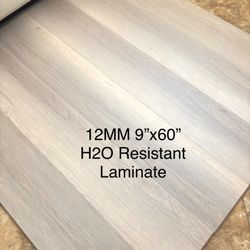 SUPER DUTY 12 MM MOISTURE RESISTANT LAMINATE FLOORING IN EXTRA WIDE  9”x60” PLANK AND PRICED TO MOVE!