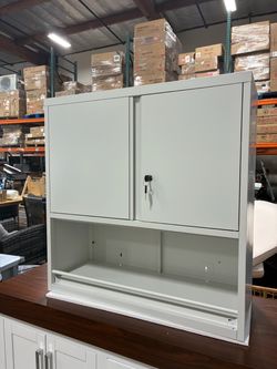 Newly assembled white Locking Metal Wall Mounted Garage Storage Cabinet with Doors and Shelves Small Lockable Hanging Floating Tool Cabinet for Shop, 