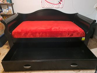 twin bed with trundle, tall dresser, nightstand and mattress.
