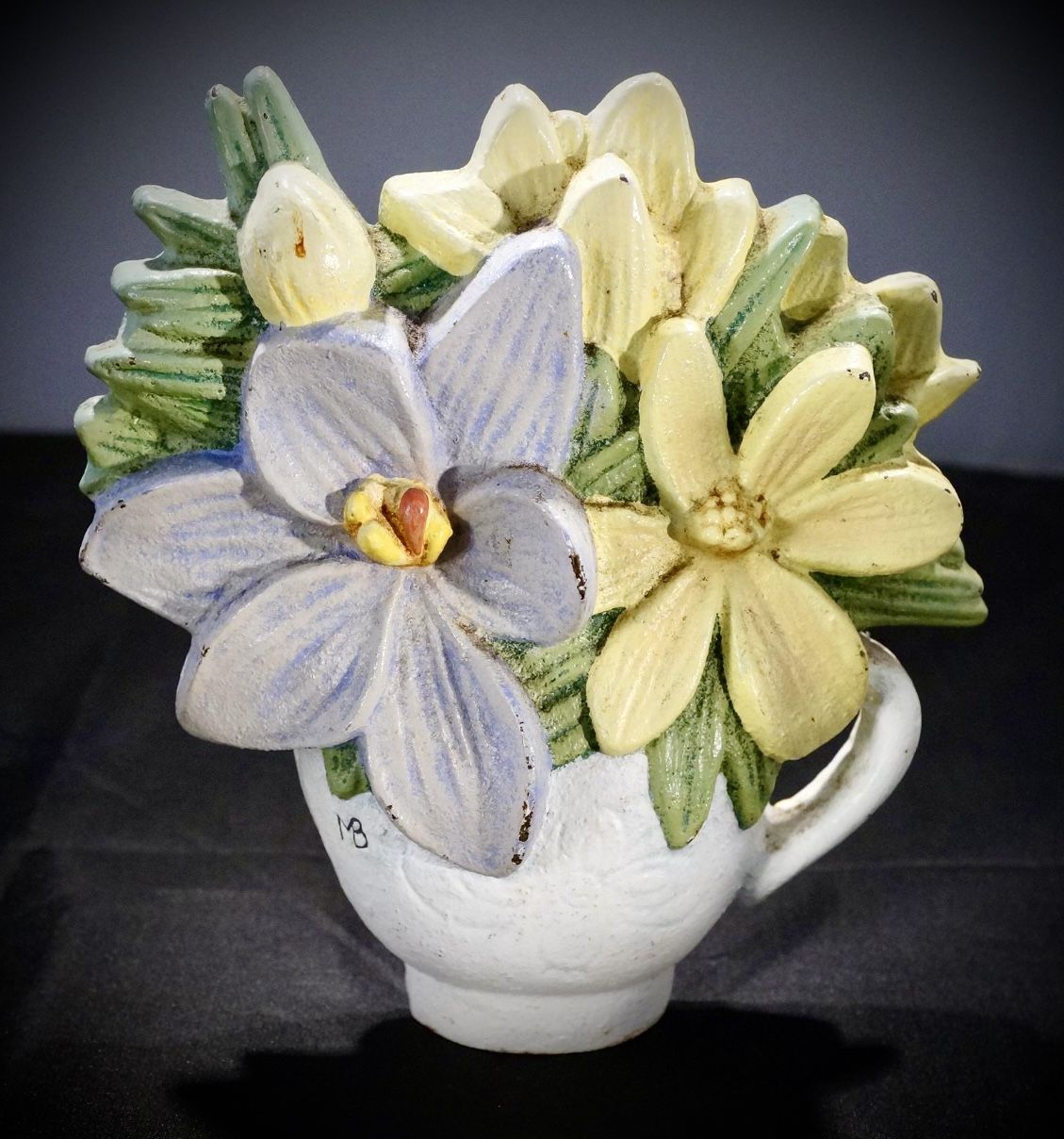 Marjolein Bastin cast iron teacup and flower doorstop.