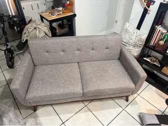 Stylish light grey sofa. Modern design.