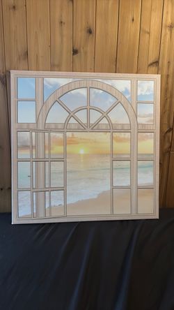 Window painting with beach and ocean in the background