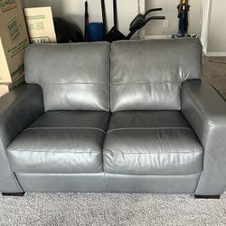 Gray Leather Couches And A Table For Sale 