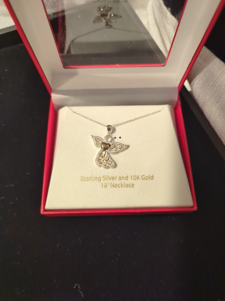 Beautiful Vintage Sterling Silver Angel Pendant with a 10k Gold Heart on a necklace.