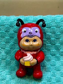 Cabbage Patch Kids Cutietown Series 1 miniature figure dressed in a red ladybug https://offerup.com/redirect/?o=Y29zdHVtZS5JdA== stands roughly 3 inch