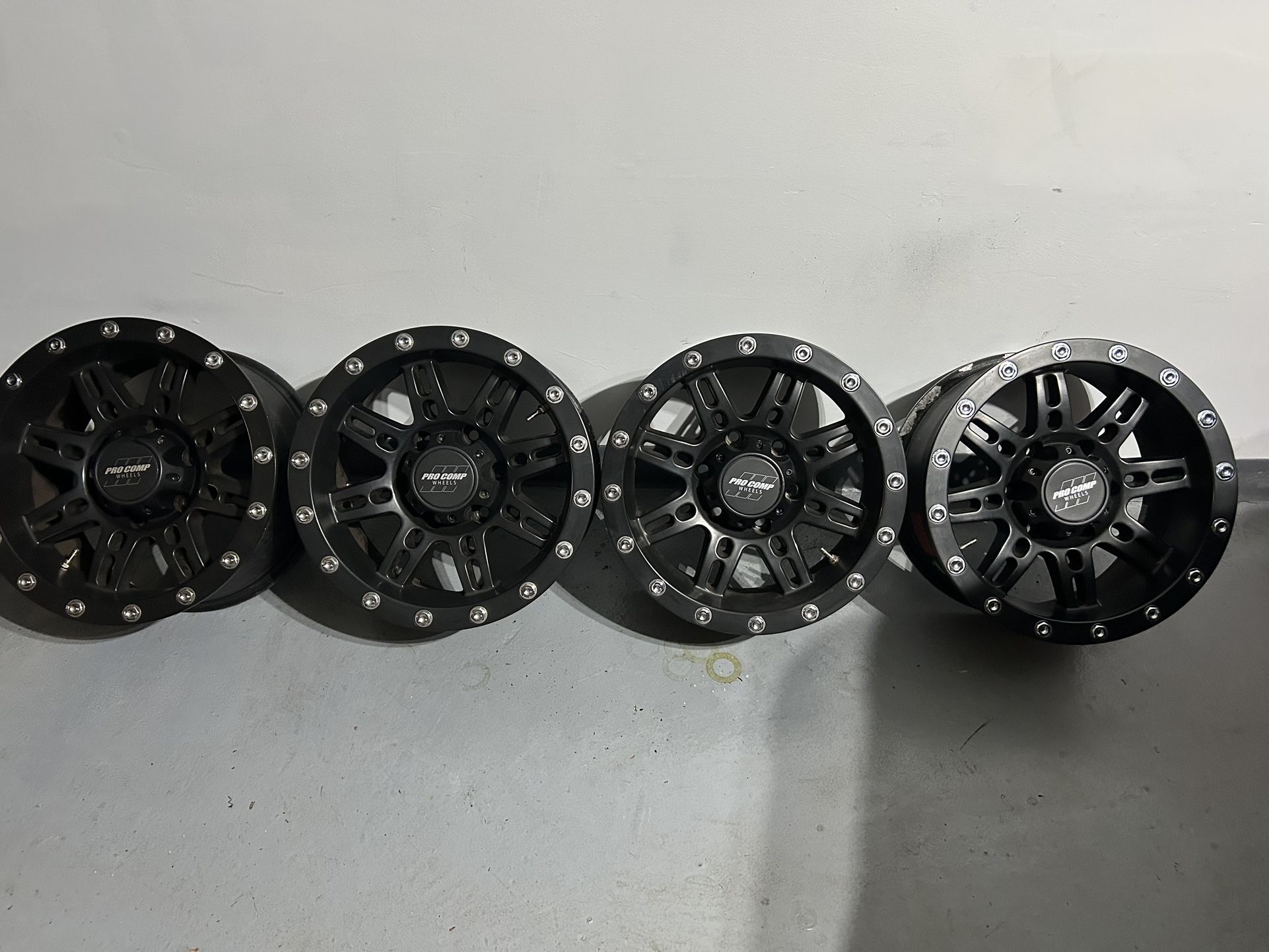 Set of 4 “satin black” Pro Comp 6 lug 16x8 Stryker 31 wheels in very good condition