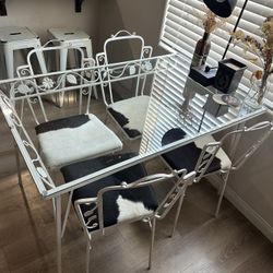 Table And Cow Hide Chairs 