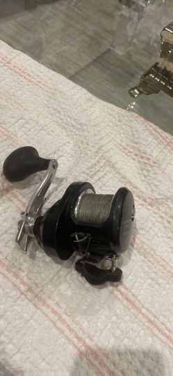 Awesome Shimano Torium 16HG fishing reel. Black body with a silver handle. Has Spectra line spooled on it. 