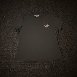 True Religion women’s black graphic tee, size Medium. Small True Religion horseshoe logo on the front with a large pink glitter Buddha/guitar graphic 