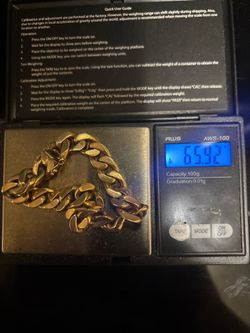 14k gold men’s bracelet and $10 gold coin