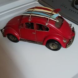 1960's metal Volkswagen beetle bug with 2 surf boards on top 12 ins long by 6 ins high 