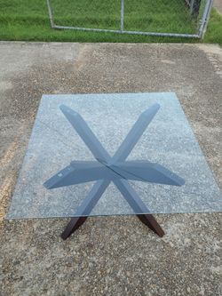 Coffee table with glass top and spider leg base