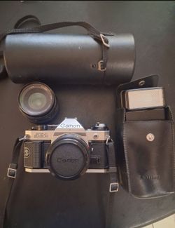 CANON AE-1 PROGRAM IN EXCELLENT CONDITION. COMES WITH FLASH, EXTRA LENSES. ASKING $360 OBO