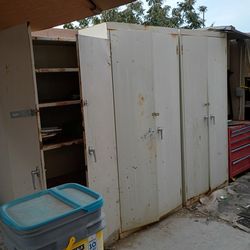 FREE... Three tall metal cabinets with shelves and all the stuff in them. Doors all shut have been on the patio and they keep the rain out to
