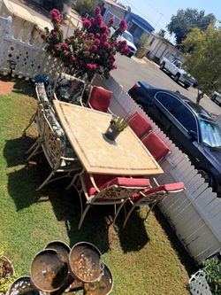 Patio set table is marbel the chairs are metal and there are 8 of them