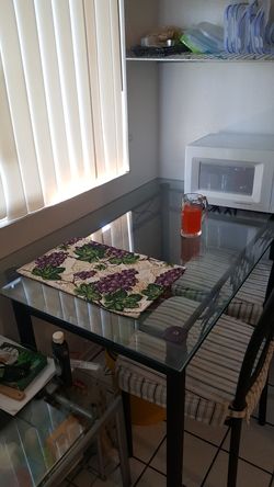 IKEA glass top metal dining table with 4 metal chairs