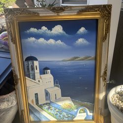 large framed artwork featuring a Mediterranean coastal village